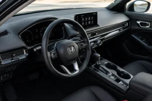Honda interior with a digital dashboard, touchscreen display, and steering wheel, showcasing the quality and reliability supported by professional Honda service & maintenance.