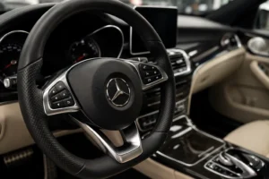 Close-up view of a Mercedes-Benz steering wheel and premium interior, showcasing advanced controls and luxury craftsmanship. The image highlights the vehicle’s cabin during inspection, representing professional Mercedes auto repair in Dubai with a focus on diagnostics, electronics, and interior system servicing.