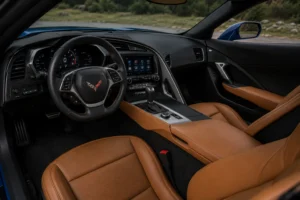 Premium Corvette interior featuring a leather-wrapped steering wheel, digital dashboard, and modern center console, highlighting the advanced cabin where professional Corvette AC repair helps maintain efficient cooling and maximum driving comfort.