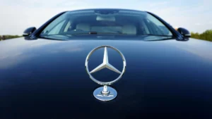 Close-up of the iconic Mercedes-Benz hood emblem on a luxury vehicle, showcasing the brand’s signature design and premium craftsmanship. The vehicle is presented in pristine condition, reflecting the high standards of service and attention to detail associated with a professional Mercedes garage in Al Quoz.