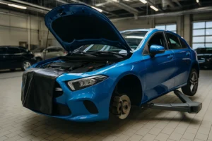 BMW Timing Chain Noise Before Startup inspection at a professional garage, showing a blue BMW on a vehicle lift with the hood open during engine diagnostics and timing chain repair.